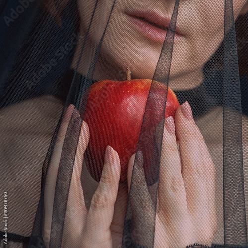 Fotografie Beautiful woman witch with poison red apple