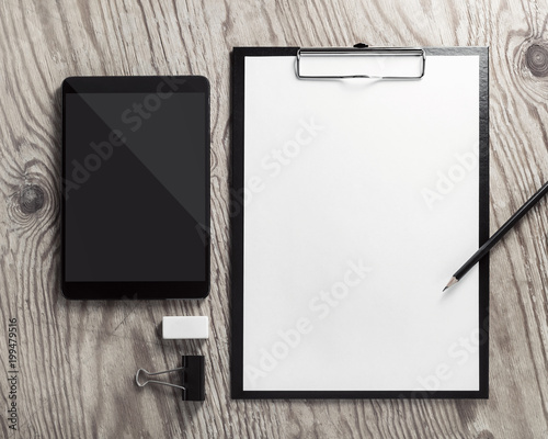 Blank corporate stationery and tablet on vintage wood background. Top view. Flat lay. photo