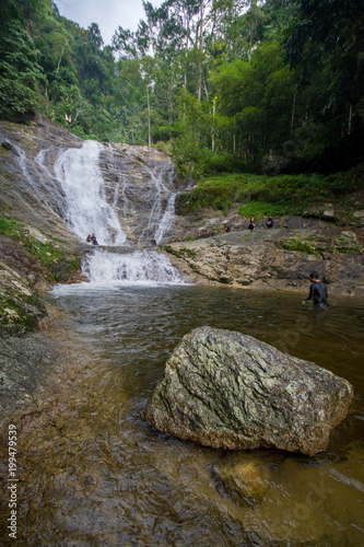 Lata Iskandar, Perak, Malaysia. March 25, 2018. A lady taking a rest at a Lata Iskandar waterfall, located along a trunk road from Tapah to Cameron Highland.