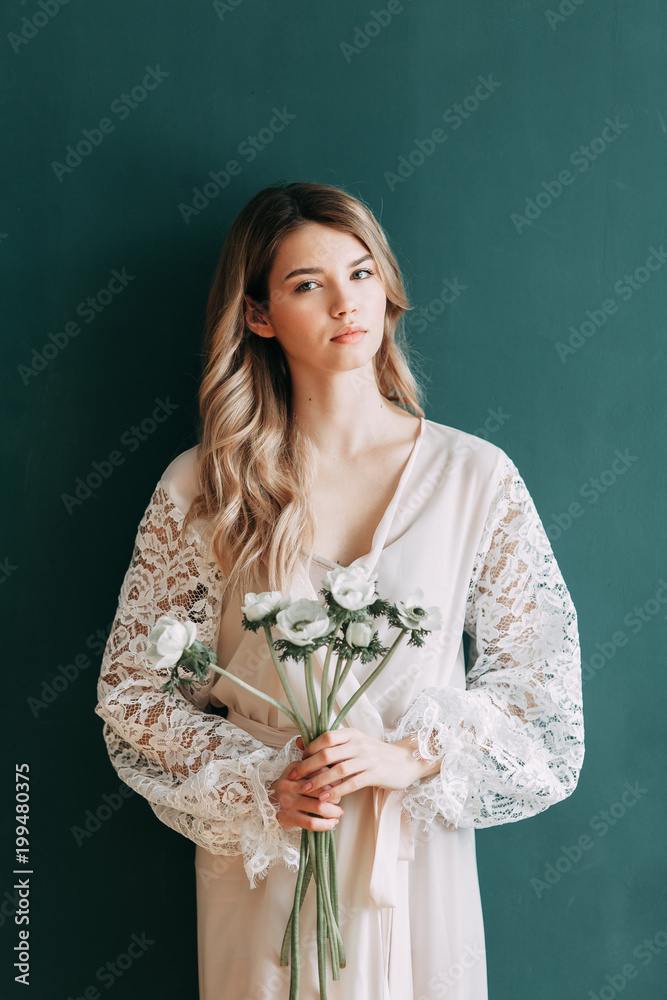 Young beautiful bride in boudoir and wedding dress, with a wreath and a bouquet in her hands. London wedding trends, stylish photoshoot Young beautiful bride in boudoir and wedding dress, with a wreath and a bouquet in her hands. London wedding trends, stylish photoshoot
