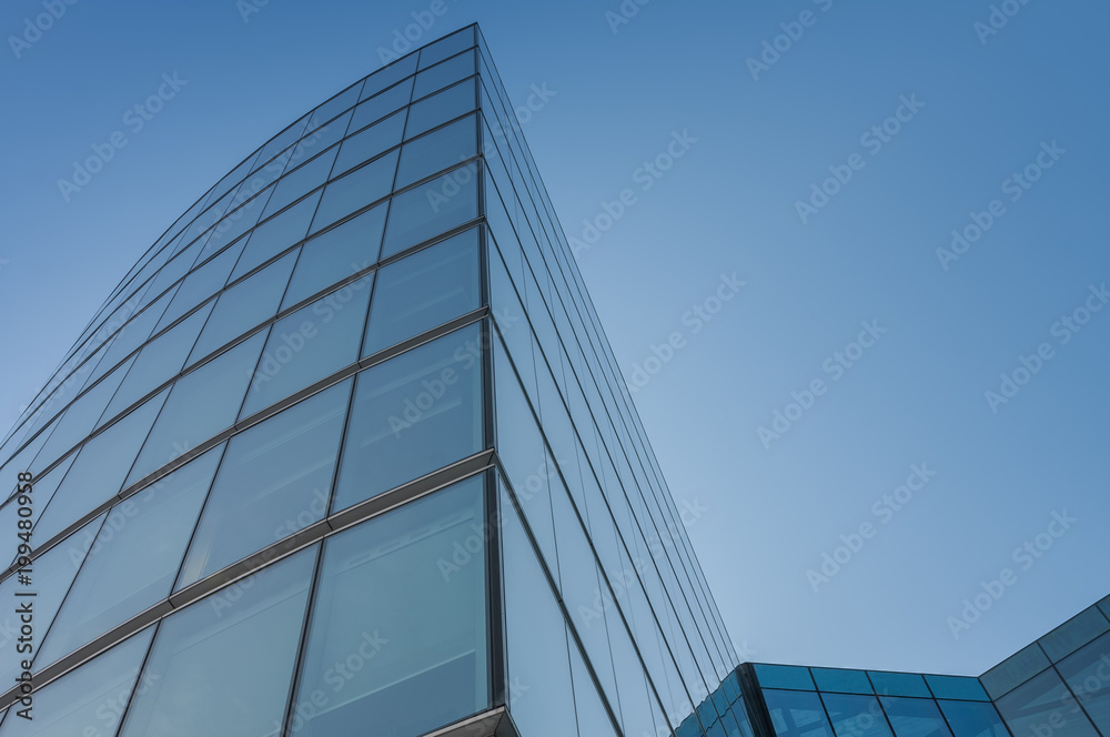 Glass facade, modern architecture with blue sky, morning shoot.