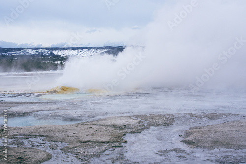 Hot Spring at Yellowstone National Park in Winter with snow and clear sky