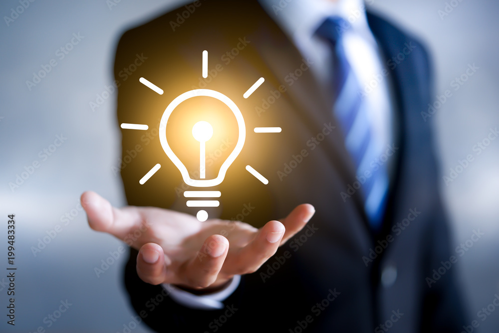 Businessman holding a Icon lightbulb. Creative idea. Concept of idea and innovation. Businessman holding a Icon lightbulb. Creative idea. Concept of idea and innovation.
