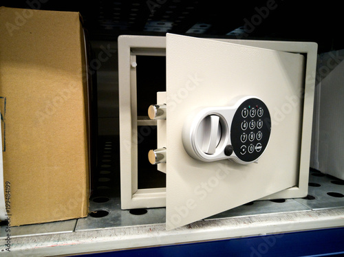 Open the metal door of a safe that is sold in the store.