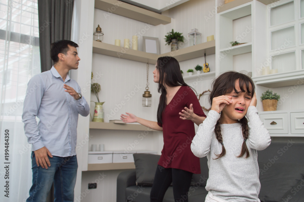 The concept of parental family quarrels, Young Couple Parents are fighting in front of children. The children are very sad to the parents quarrel. Children are crying and headaches. The concept of parental family quarrels, Young Couple Parents are fighting in front of children. The children are very sad to the parents quarrel. Children are crying and headaches.