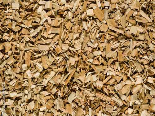 Light brown tan wood chips create abstract rough-textured organic background surface
