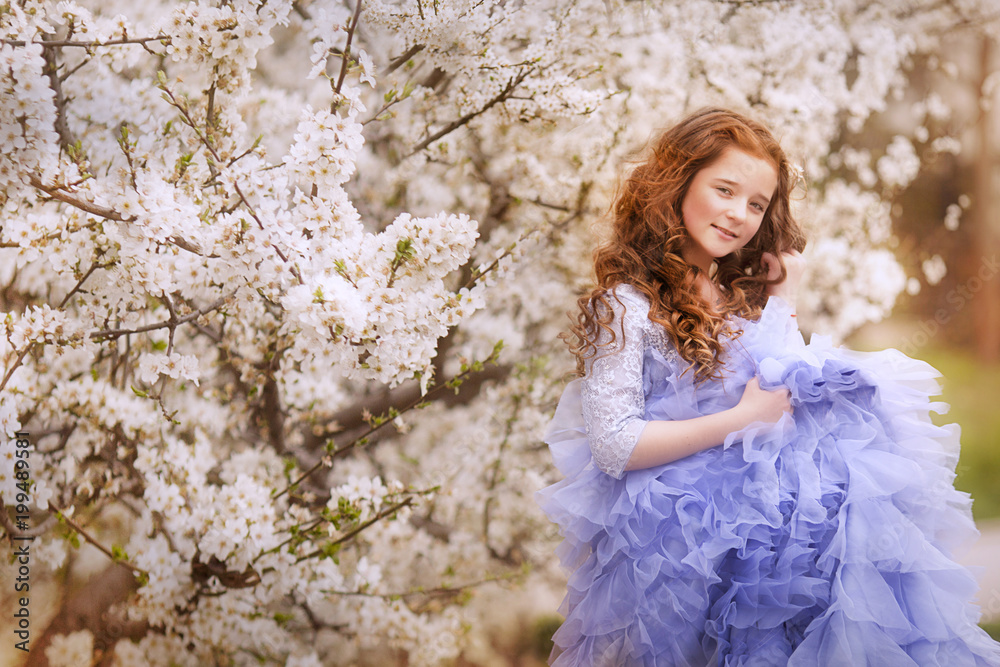 Adorable little girl in blooming cherry tree garden on beautiful spring day. Adorable little girl in blooming cherry tree garden on beautiful spring day.