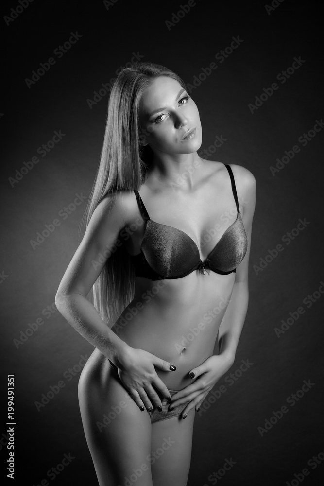 Fototapeta premium young sexy girl in underwear on a black background