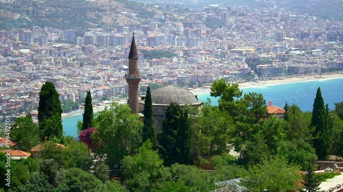 Alanya Suleymaniye Camii Mosque at the inner castle. Keykubat Beach and Alanya resort city in the background. Mosque built by Alaeddin Keyqubad in 13th century, was reconstructed by Suleiman the Magni photo