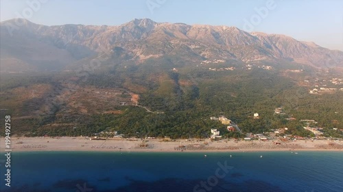 Beach shore with mountains in background photo