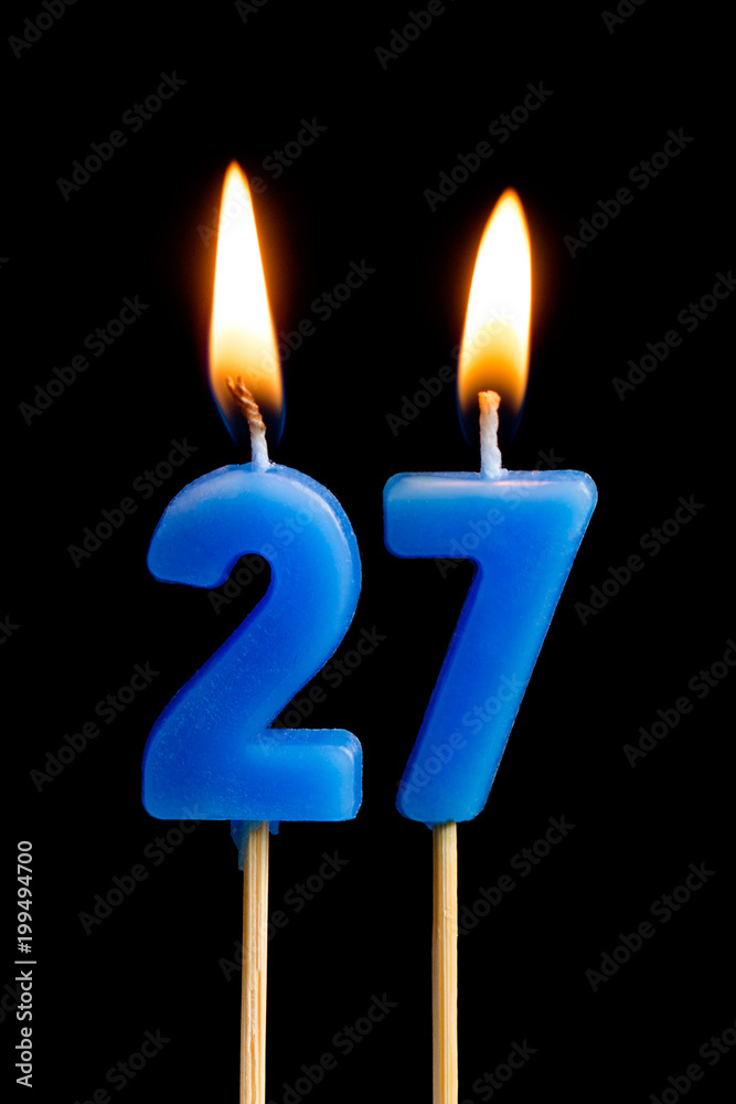 Burning candles in the form of 27 twenty seven (numbers, dates) for cake isolated on black background. The concept of celebrating a birthday, anniversary, important date, holiday, table setting Burning candles in the form of 27 twenty seven (numbers, dates) for cake isolated on black background. The concept of celebrating a birthday, anniversary, important date, holiday, table setting