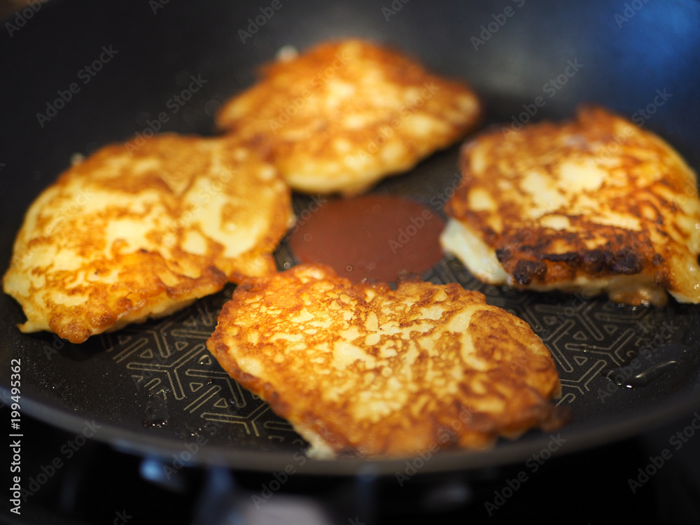 Delicious pancakes with apple sprinkled with sugar fried in hot oil. Delicious pancakes with apple sprinkled with sugar fried in hot oil.