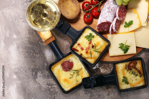 Photography Delicious traditional Swiss melted raclette cheese on diced boiled or baked potato