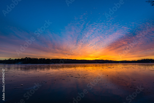 Winter sunset over icy lake