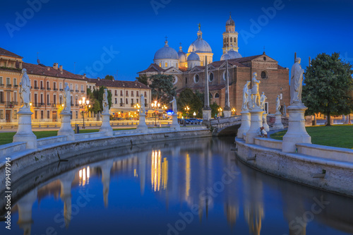 View of statues in Prato della Valle at dusk and Santa Giustina Basilica visible in background, Padua, Veneto photo