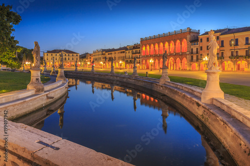 View of statues in Prato della Valle at dusk and Loggia Amulea visible in background, Padua, Veneto