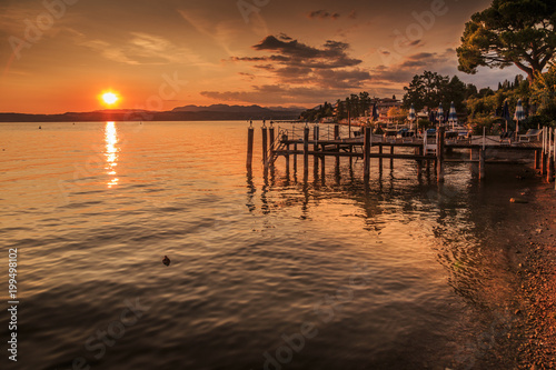 View of golden sunset on Lake Garda, Sirmione, Lake Garda, Lombardy, Italian Lakes
