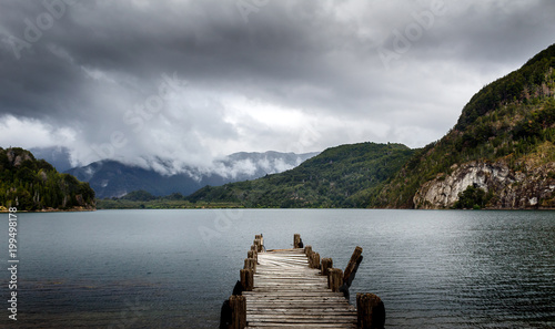 Dock and lake with mountains and cloudy sky Patagonia Argentina photo