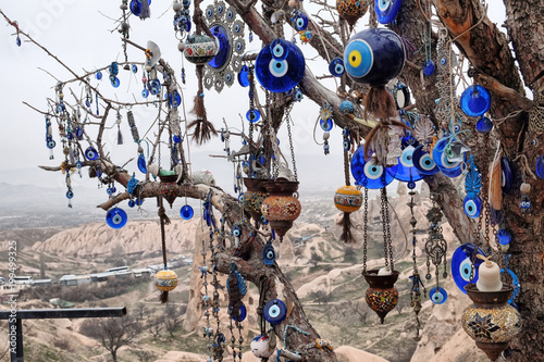 Nazar, charms to ward off the evil eye , on the branches of a tree in Cappadocia, Turkey