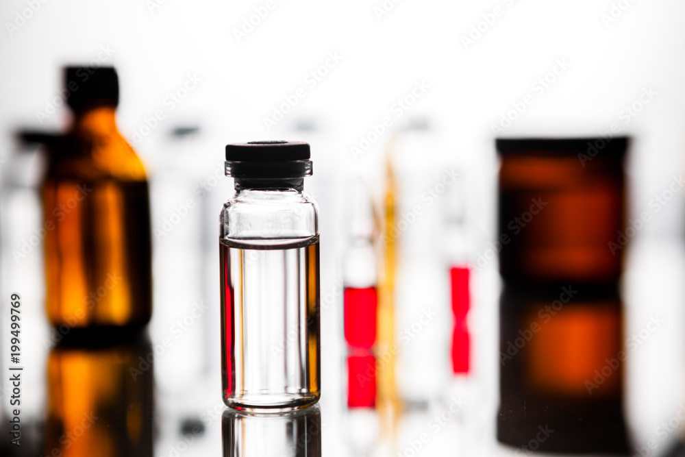 Group object of liquid medicinal agent in limpid glassware in medical laboratory. Group of ampoules with a transparent medicine in medical laboratory Group object of liquid medicinal agent in limpid glassware in medical laboratory. Group of ampoules with a transparent medicine in medical laboratory