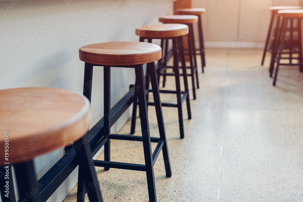Empty cafe. Wooden chairs beside bar counter. Empty cafe. Wooden chairs beside bar counter.
