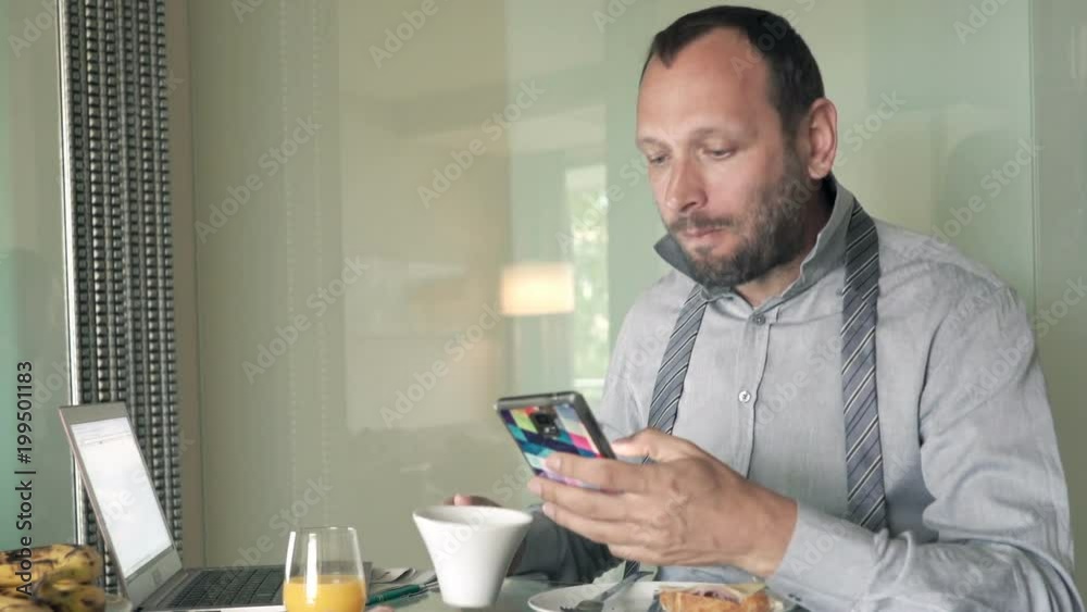 Young businessman texting on smartphone during breakfast at home
Young businessman texting on smartphone during breakfast at home