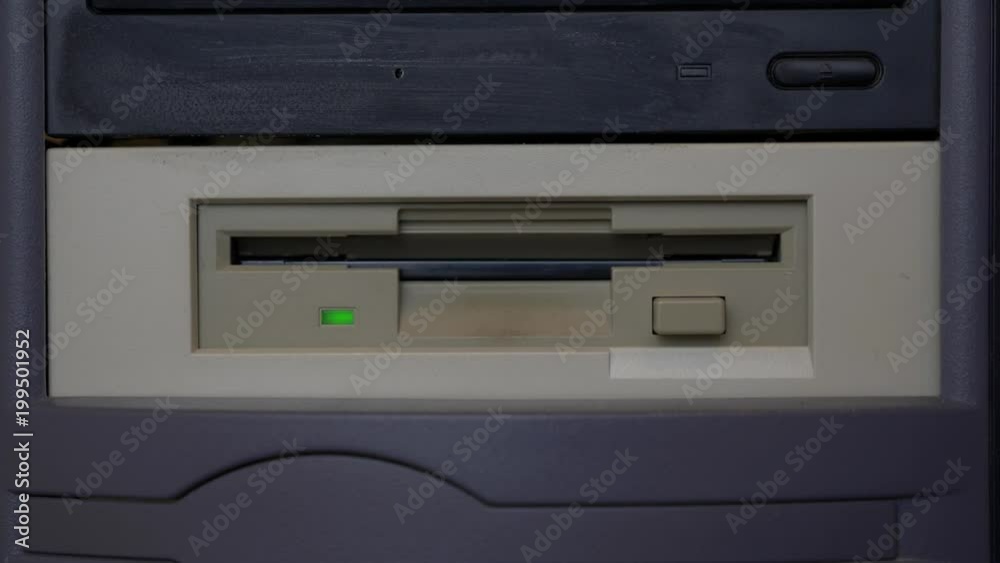 Loading a vintage floppy disk into an old computer drive