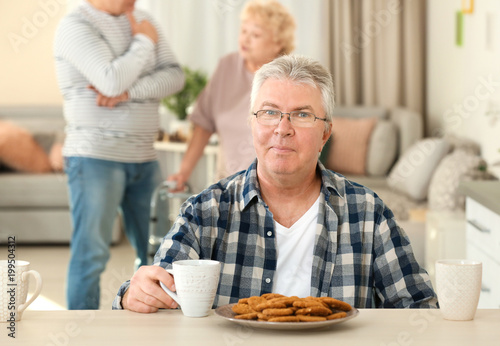Senior man having breakfast...