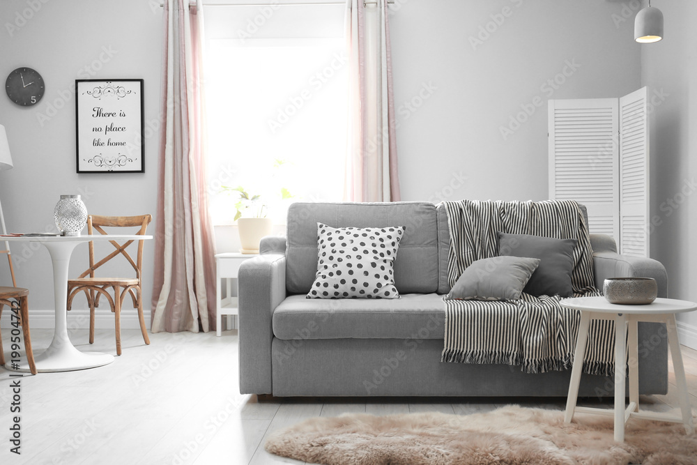 Fototapeta premium Stylish living room interior with comfortable couch