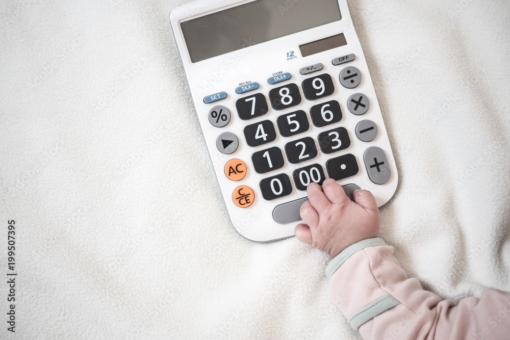 Baby hand and calculator with text space background : concept of expense for kid and baby, Kid business value Baby hand and calculator with text space background : concept of expense for kid and baby, Kid business value