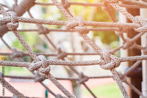 Close-up of rope knot line tied together with playground background.selective focus. photo