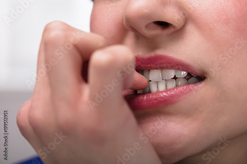 Businesswoman Biting Her Fingernail
