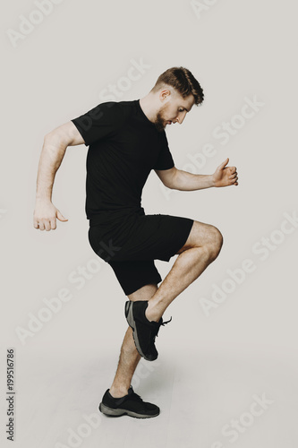 Full lenght photo of a sportsman training on a white background.