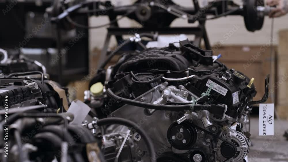 Automobile sports car manufacturing plant engineers working on vehicles Automobile sports car manufacturing plant engineers working on vehicles