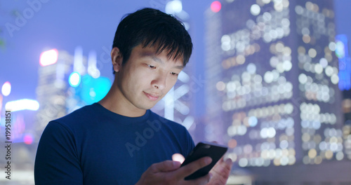 Man use of mobile phone in Hong Kong city