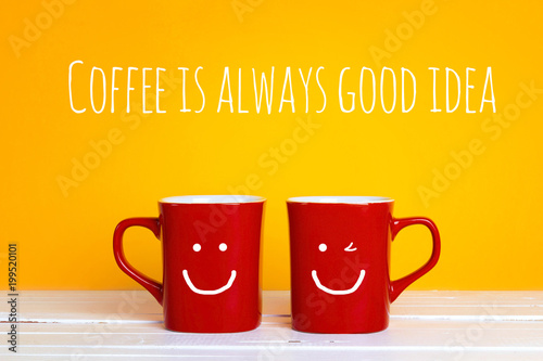 Two red coffee mugs with a smiling faces on a yellow background with the phrase  Coffee is alwayas good idea.