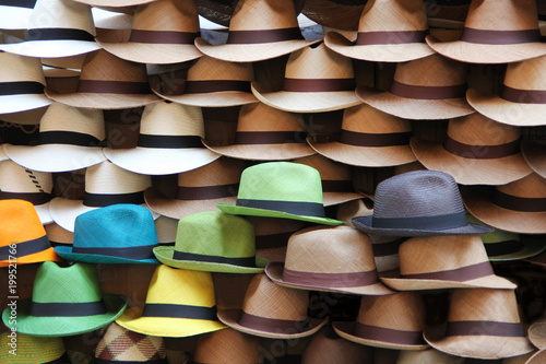 A selection of Panama hats piled up against a wooden door, Cartagena, Colombia.