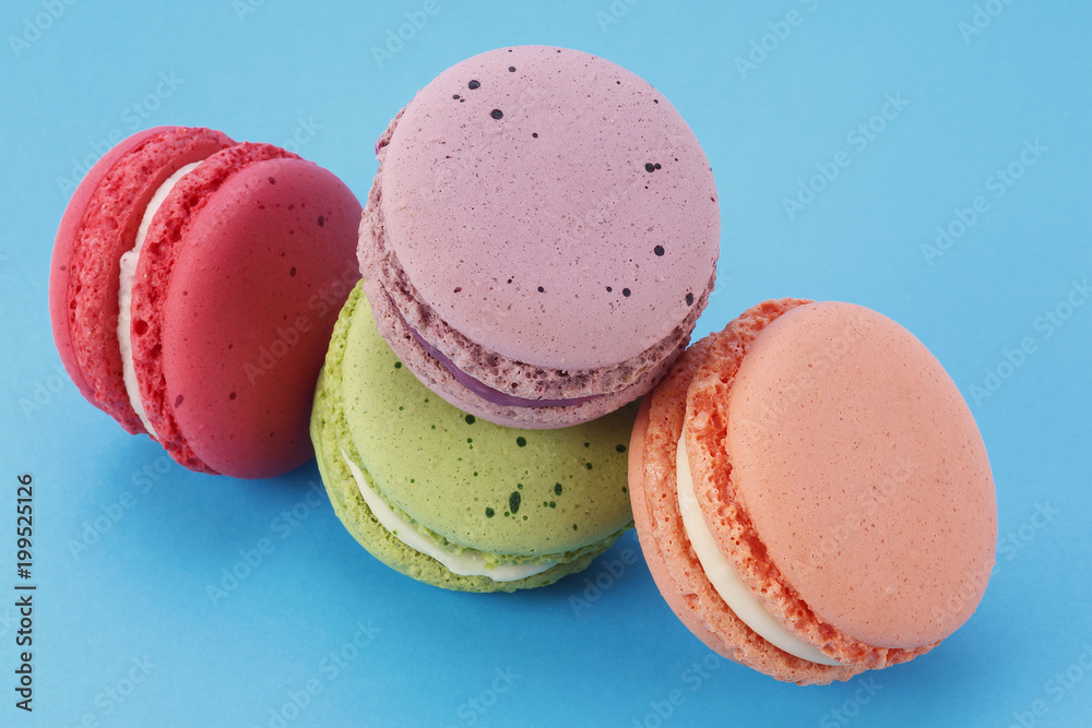 Sweet and colorful French macarons on blue background Sweet and colorful French macarons on blue background