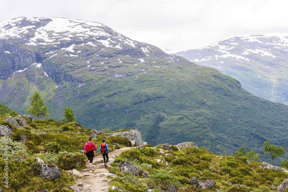 Woman and boy hiking in mountain landscape