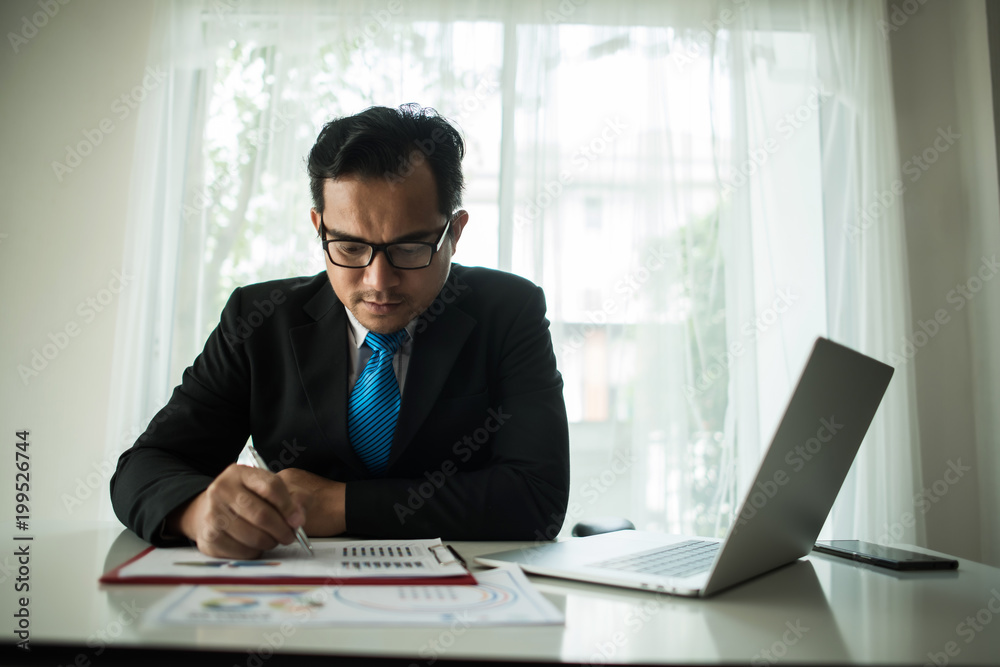 Young businessman working with laptop at office Young businessman working with laptop at office