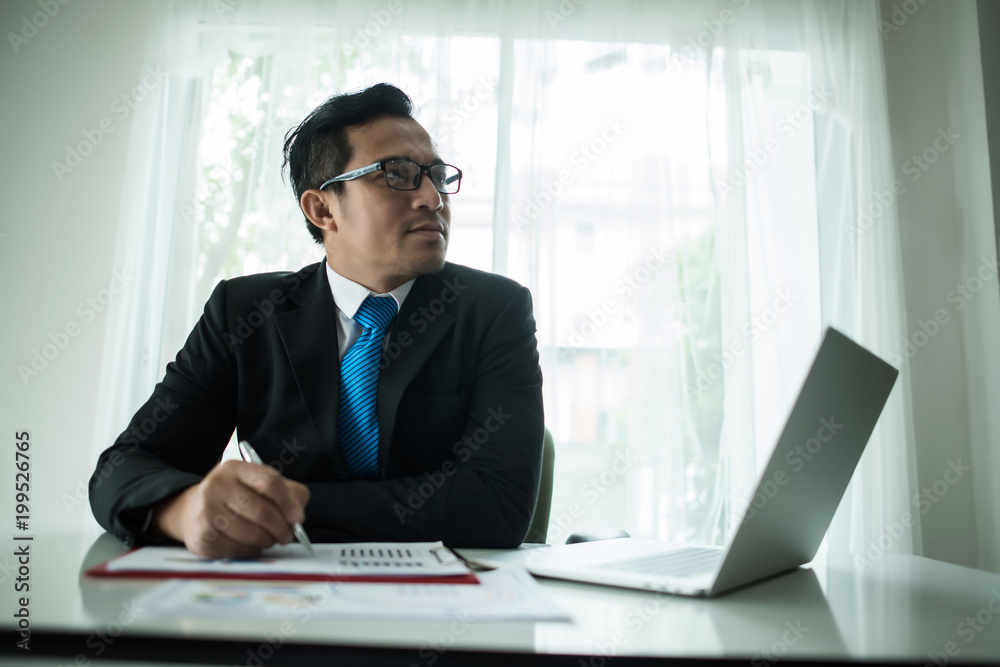 Young businessman working with laptop at office Young businessman working with laptop at office