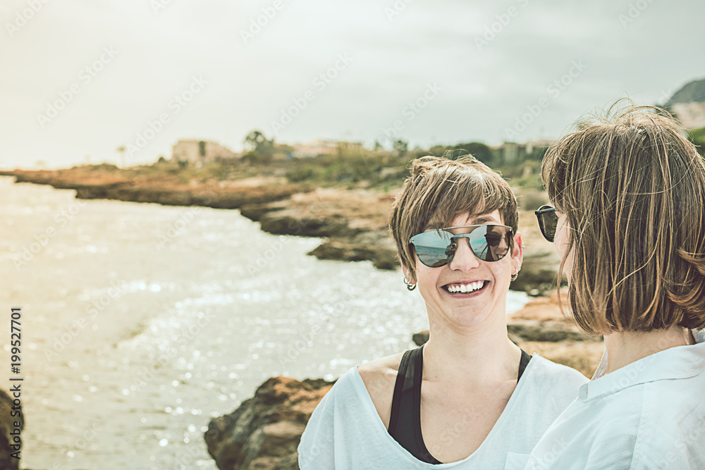 Two happy, smiling girls on the beach. Social network style photography