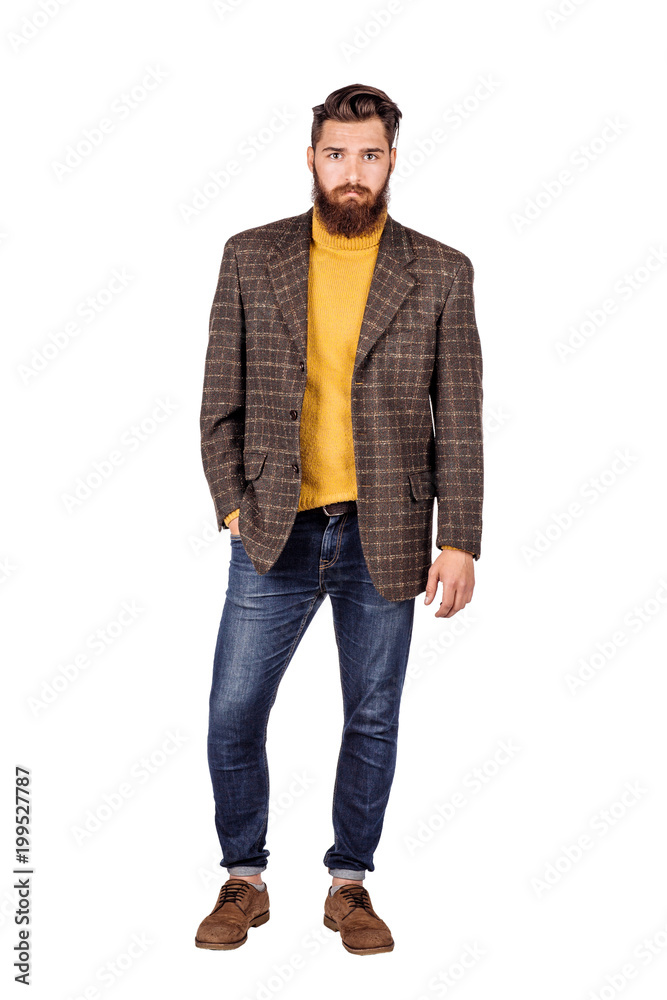 Handsome young man with beard full height standing against white background.