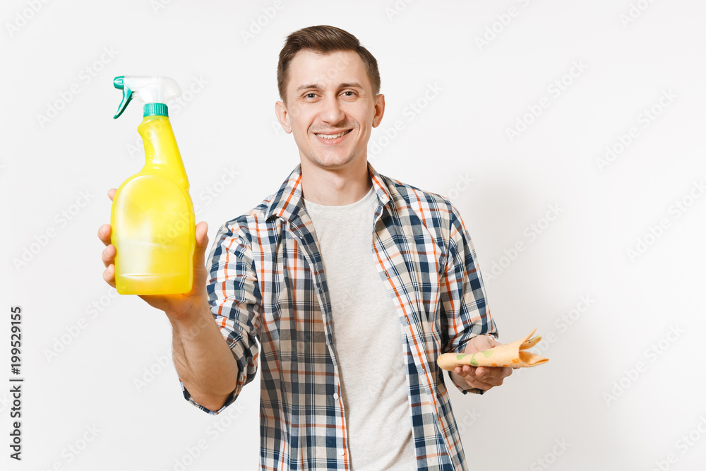Young housekeeper man holding cleaning rag, white blank empty spray bottle with cleaner liquid isolated on white background. Male doing house chores. Copy space for advertisement. Cleanliness concept. Young housekeeper man holding cleaning rag, white blank empty spray bottle with cleaner liquid isolated on white background. Male doing house chores. Copy space for advertisement. Cleanliness concept.