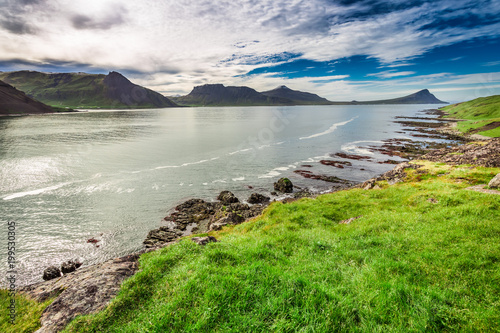 Mountains over sea shore in...
