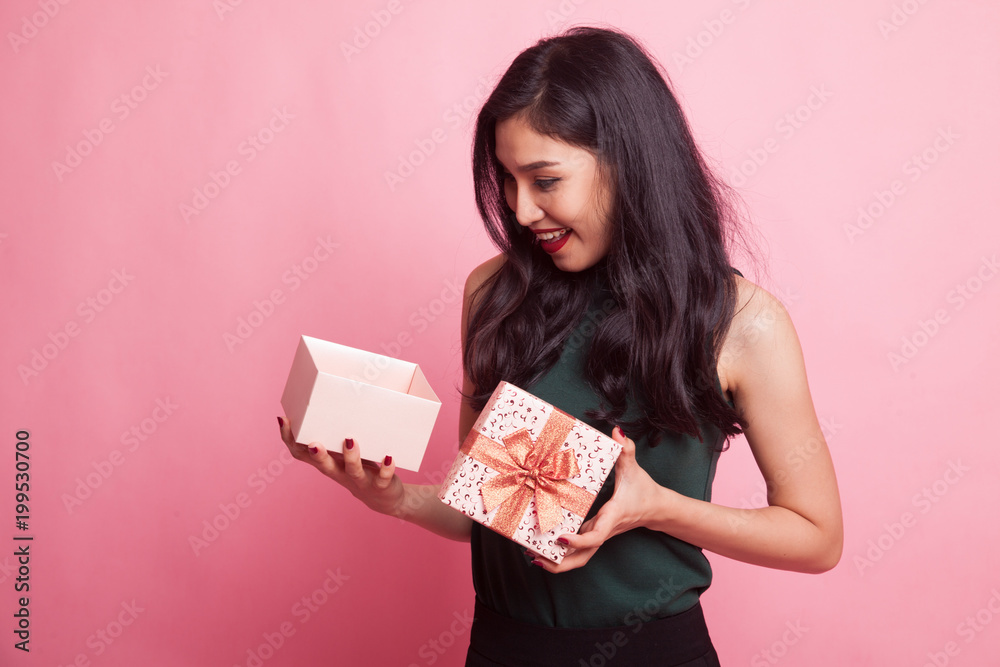 Young Asian woman open a gift box. Young Asian woman open a gift box.