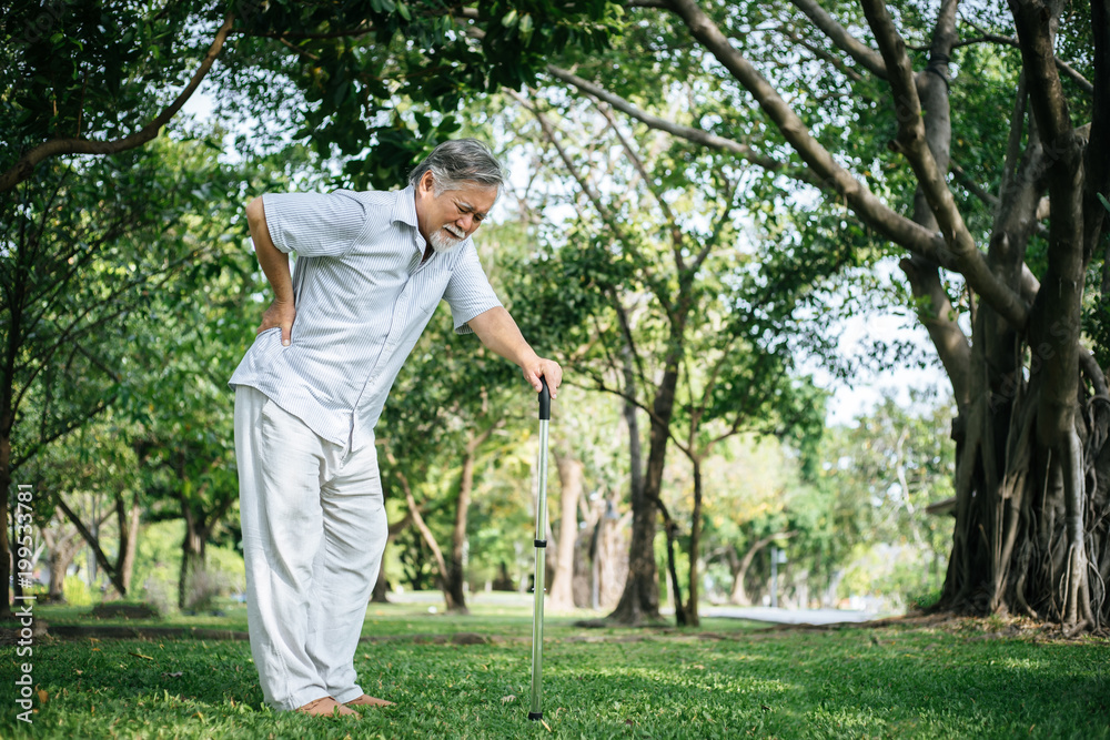 Old man with cane suffering from back pain Old man with cane suffering from back pain
