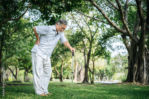 Old man with cane suffering from back pain © Johnstocker