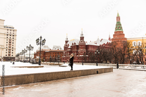 Portrait in full growth, Russian beautiful woman in a mink coat on the Red Square in Moscow in Christmas time