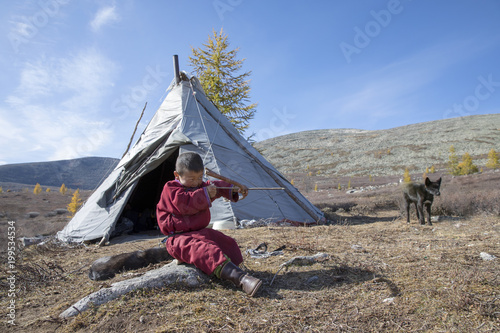 tsaatan kid in a taiga of northern Mongolia photo
